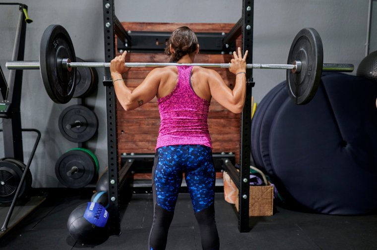 Woman lifting weights in the gym