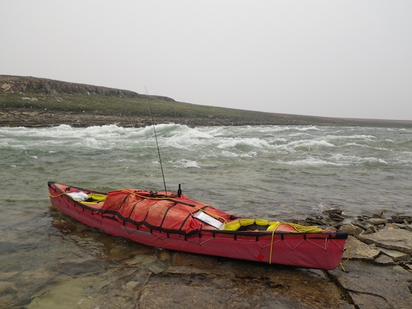 canoe beside rapids in arctic