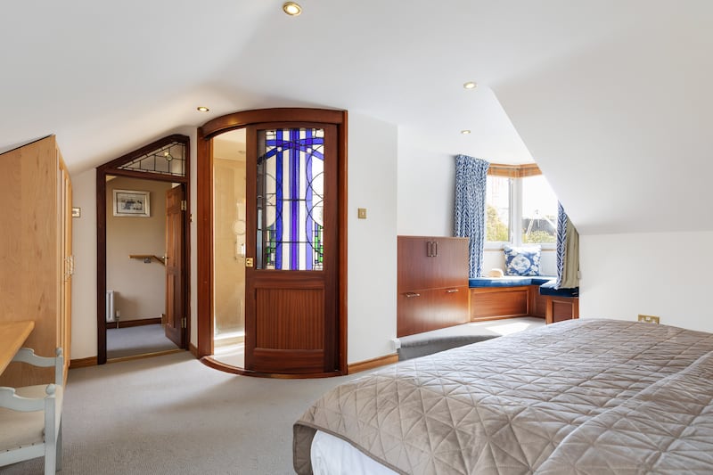Dormer bay window seat and stained-glass door to en suite