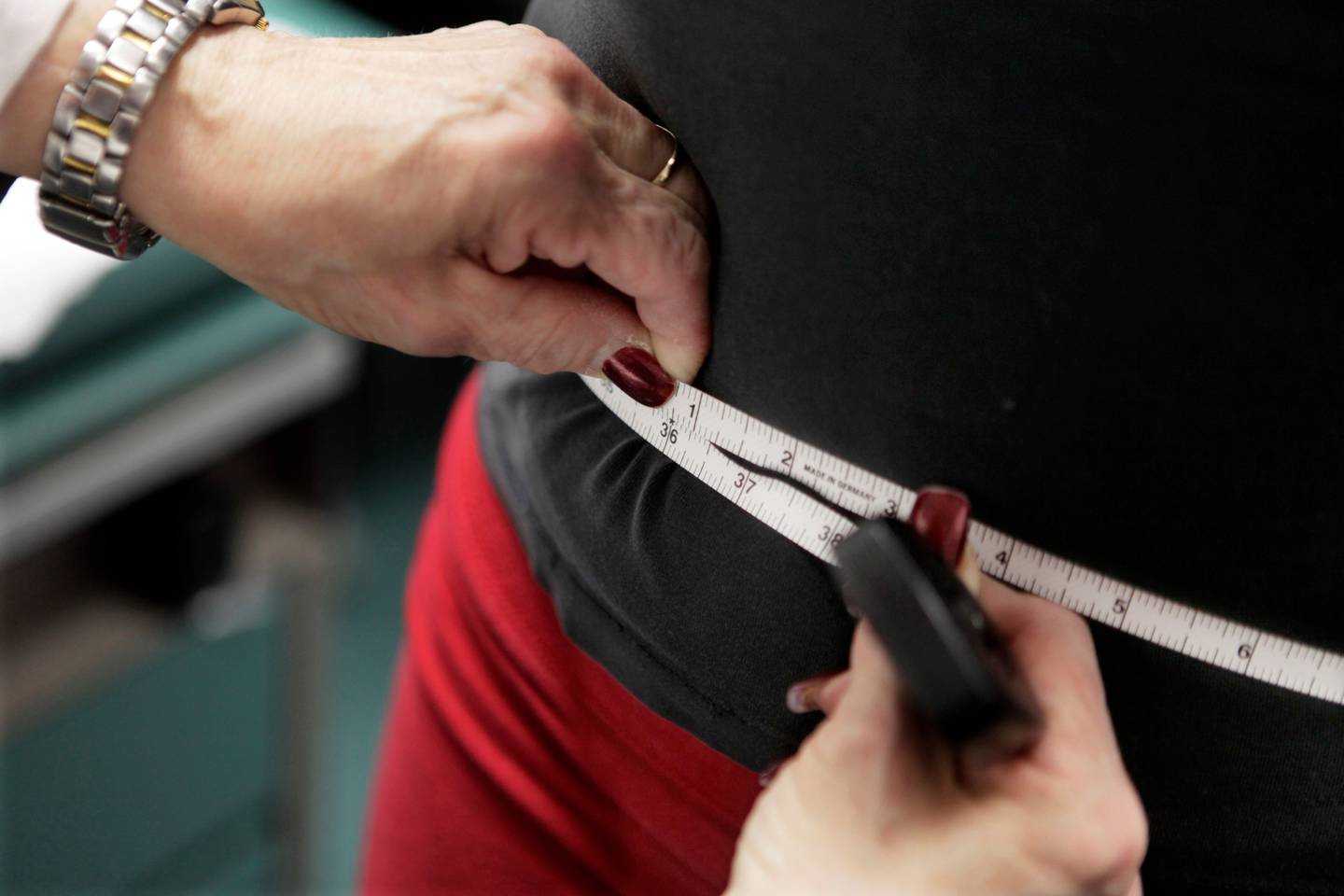 FILE - A subject's waist is measured during an obesity prevention study in Chicago on Jan. 20, 2010. (AP Photo/M. Spencer Green, File)