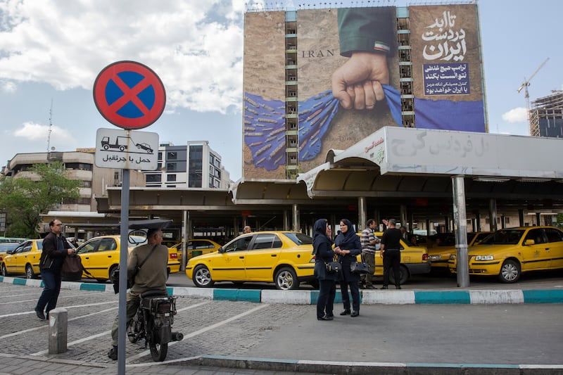 A billboard in Tehran depicts a hand representing Iran holding the Strait of Hormuz. Photograph: Arash Khamooshi/The New York Times
                      
