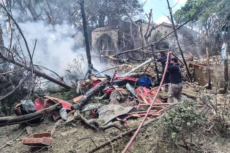 Rescue workers extinguish a fire following an Israeli air strike on the southern Lebanese town of Kfar Roummane on Monday. Photograph: Abbas Fakih/AFP via Getty