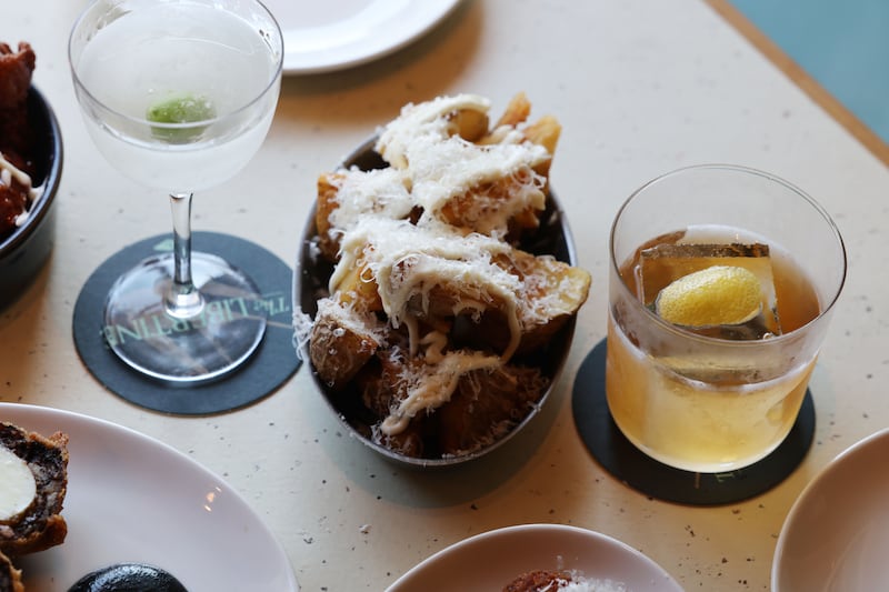 A Weaver's Grace cocktail; crispy potatoes with parmesan and aioli; and a backroom cocktail. Photograph: Alan Betson