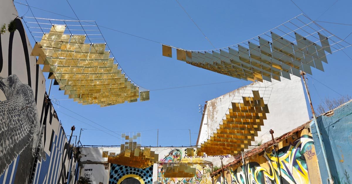 kinetic mirrored installation in portugal by moradavaga evokes a shoal of golden fish