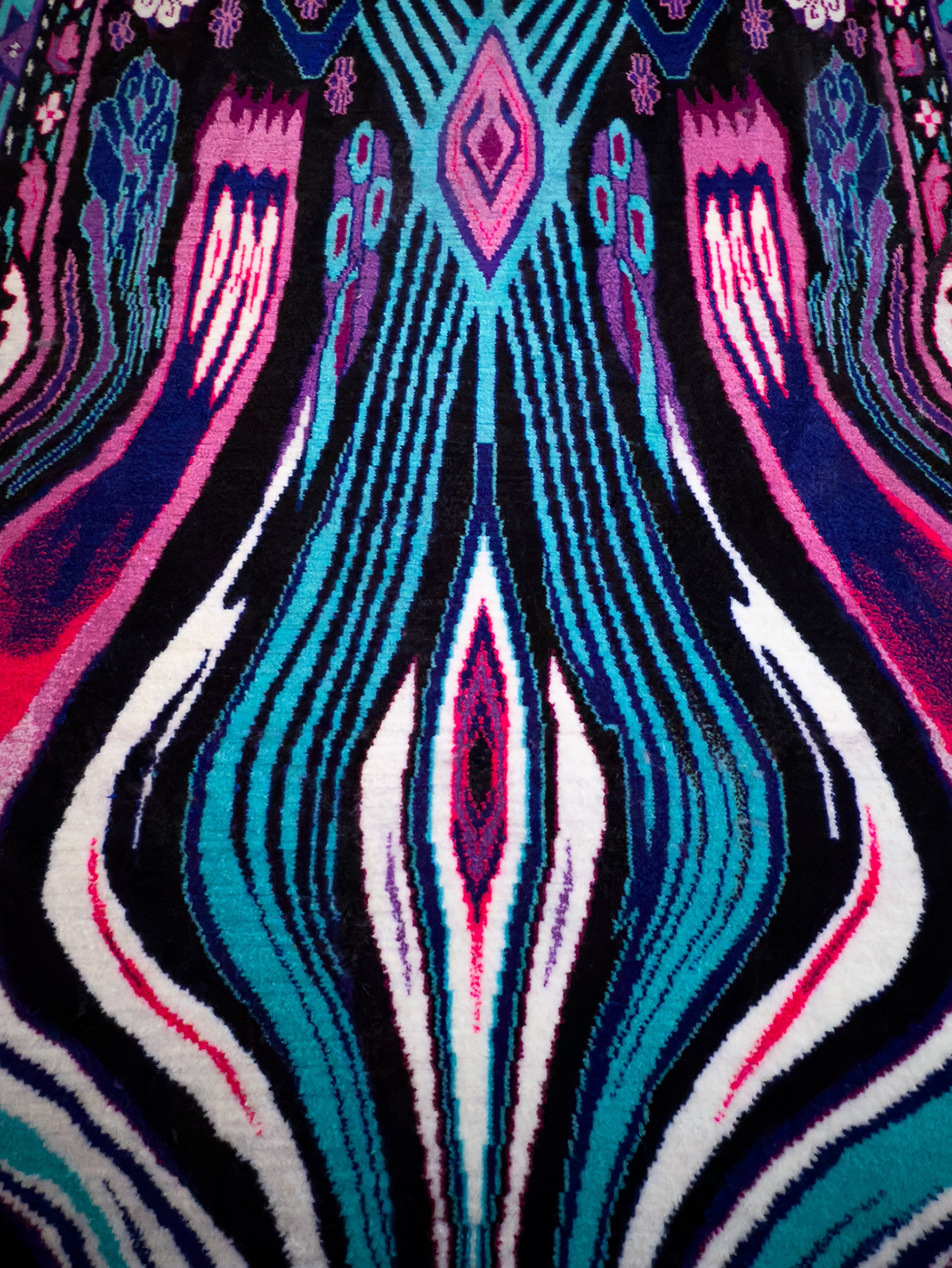 a detail of a colorful, uniquely patterned wool carpet