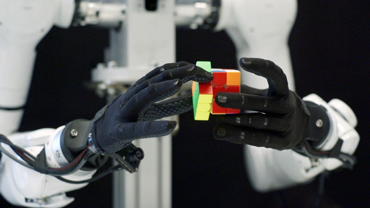 A robot twists a Rubik's cube.