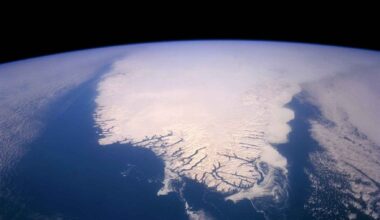 Satellite view of Arctic sea ice and open ocean, showing the polar ice cover from above Earth.