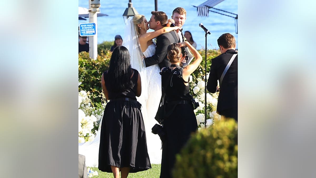 Ava Locklear and Tyler Farrar walking together at their wedding in Montecito, California