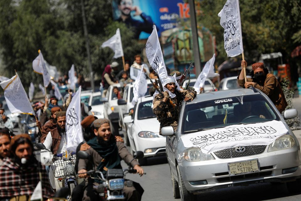 Taliban members drive in a convoy to celebrate the first anniversary of the withdrawal of US troops from Afghanistan. Photo: Reuters/Ali Khara