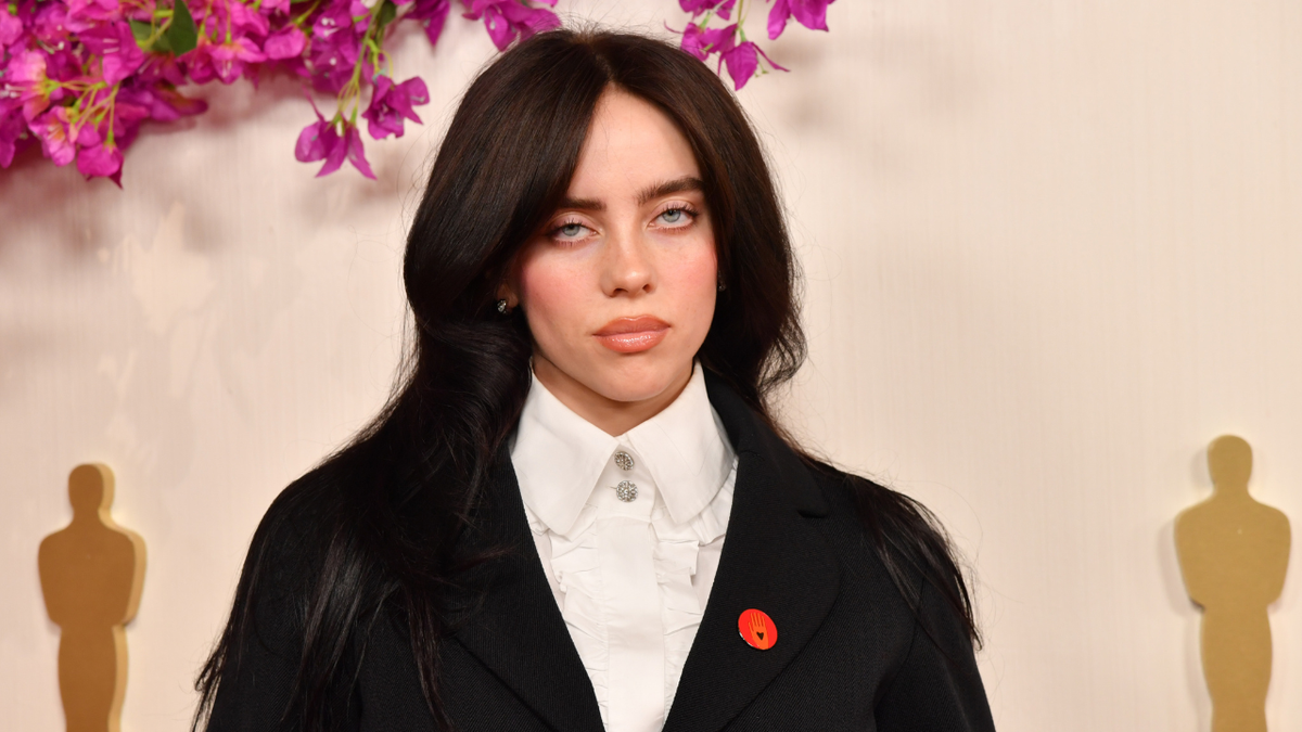 Billie Eilish standing on the red carpet at the Academy Awards in Hollywood, California