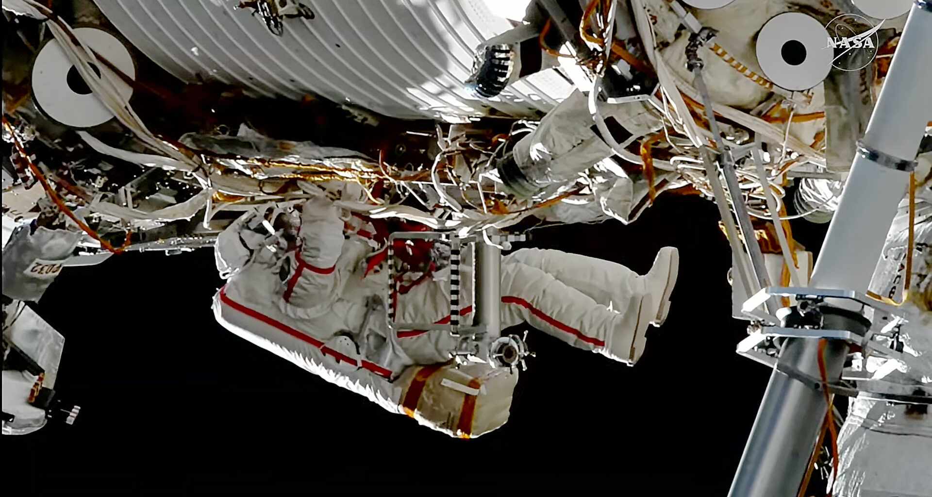 Roscosmos cosmonaut Sergey Ku-Sverchkov installs a solar radiation experiment during a spacewalk on the outside of the International Space Station.