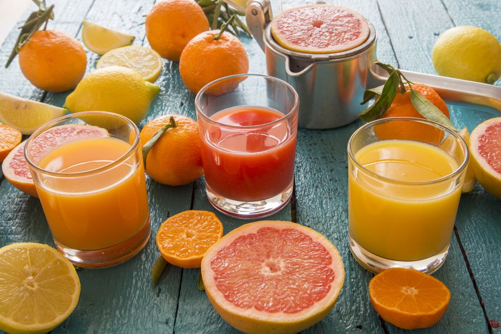 Citrus fruit alongside fruit juice