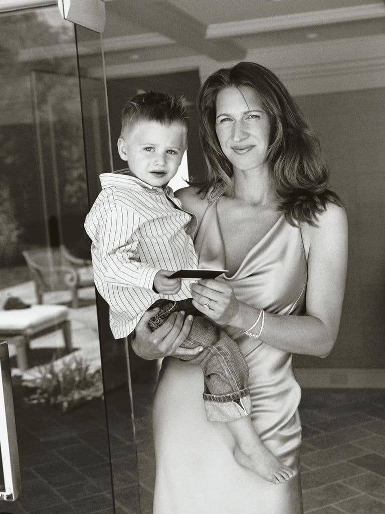 Steffi holding one of their children as a toddler