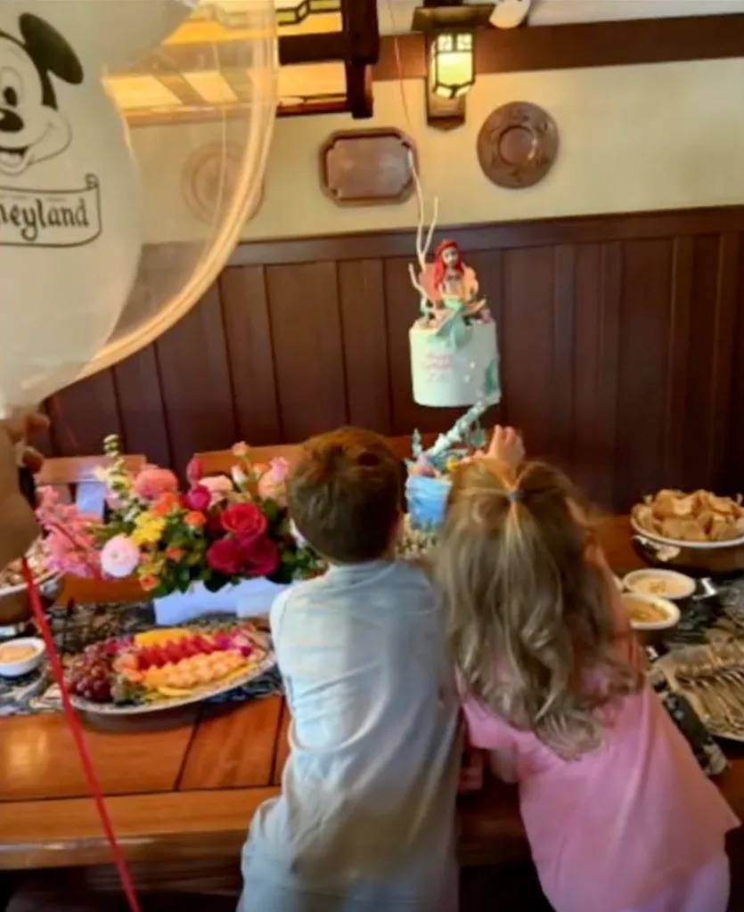Archie and Lilibet looking at Lilibet's Little Mermaid-themed cake on Lilibet's 4th birthday