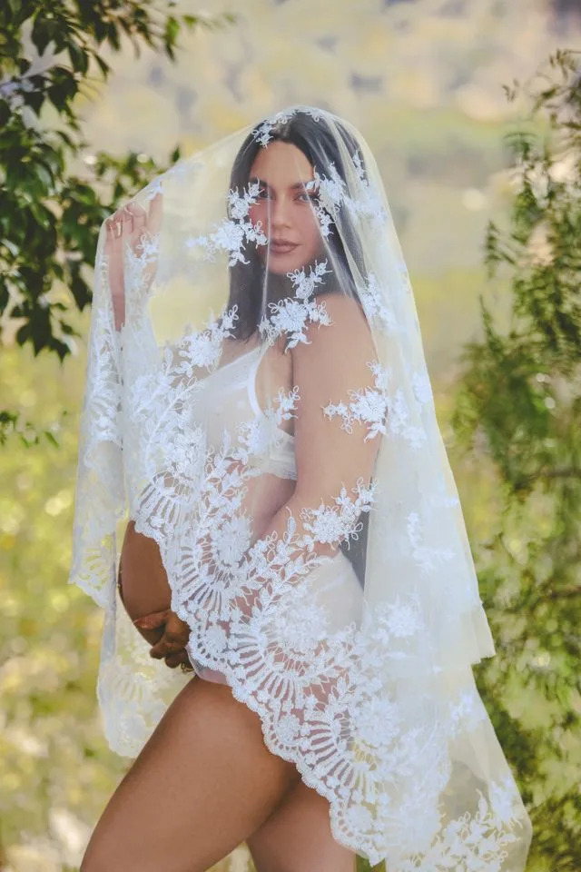 Vanessa Hudgens poses in white lingerie and a lace veil in a pregnancy photo shoot by photographer Emilynn Rose in October 2025.Credit: Emilynn Rose