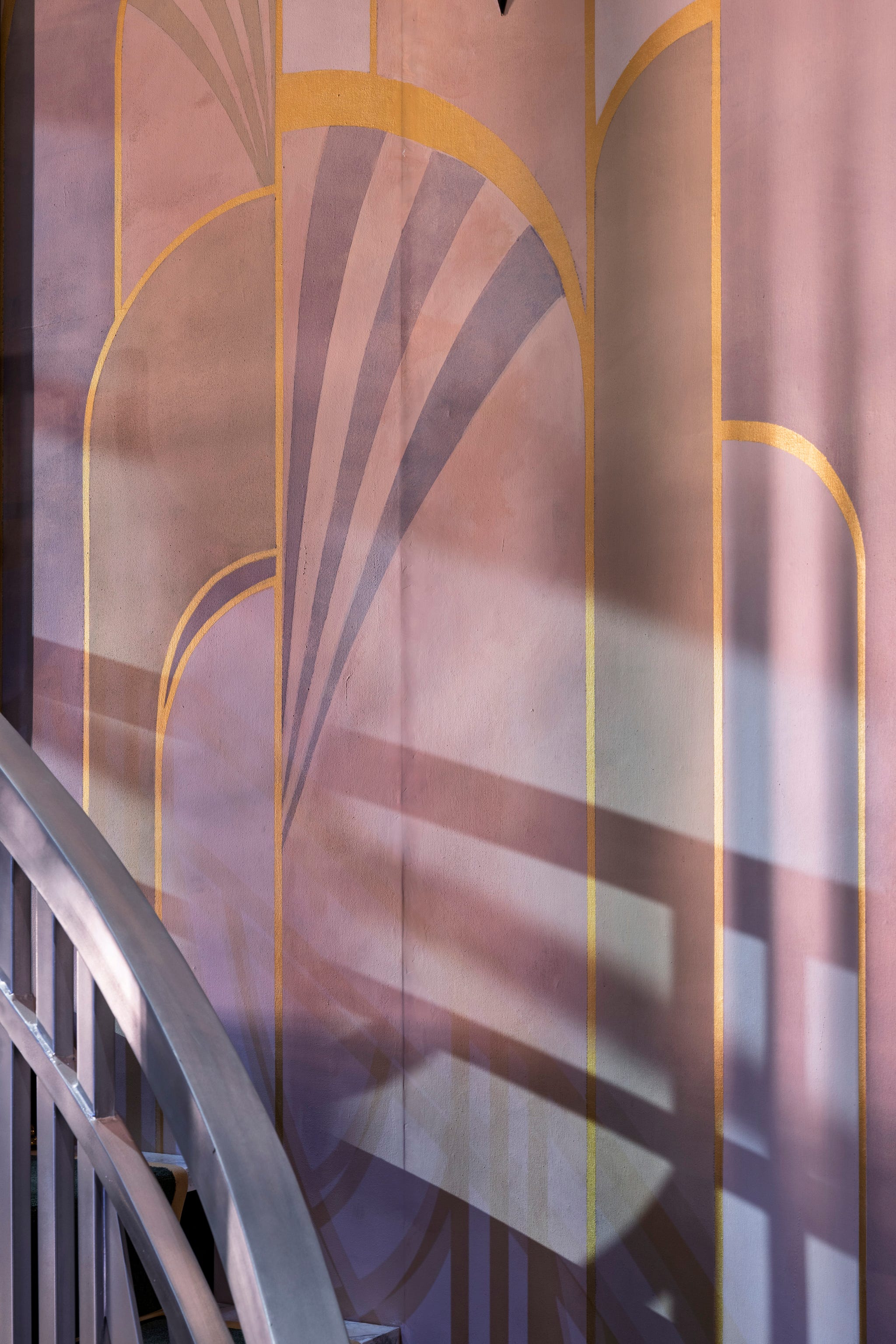 Stylized wall design with curved shapes and golden lines.