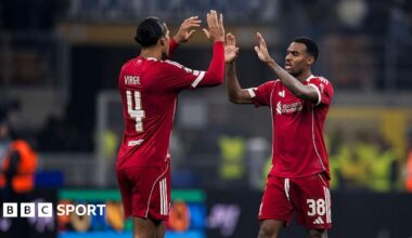Virgil van Dijk and Ryan Gravenberch high-five each other.