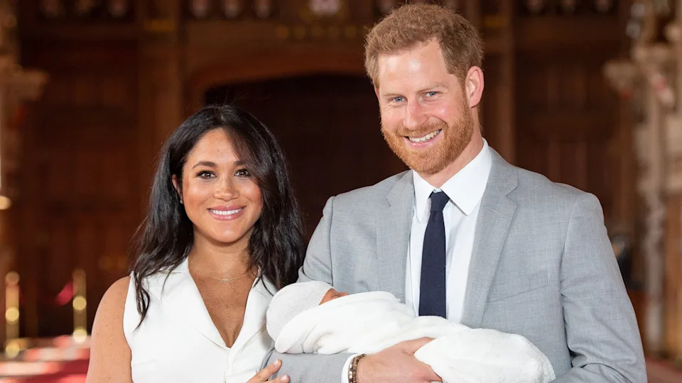 Prince Harry and his wife Meghan, Duchess of Sussex, pose for a photo with their newborn baby son, Archie, in St George's Hall at Windsor Castle