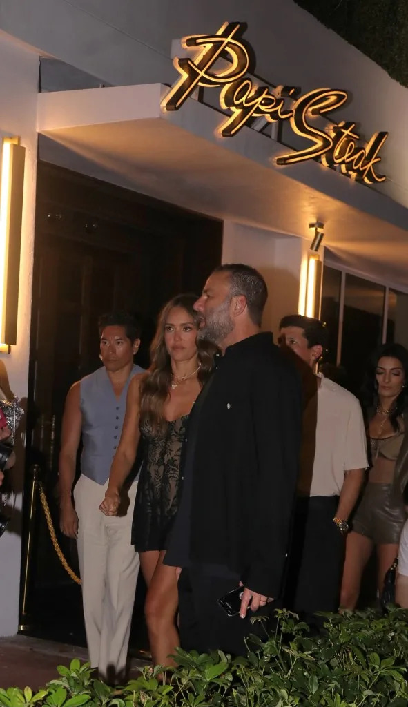 The actress (seen here at Papi Steak) looked chic in a lace mini dress. / SplashNews.com