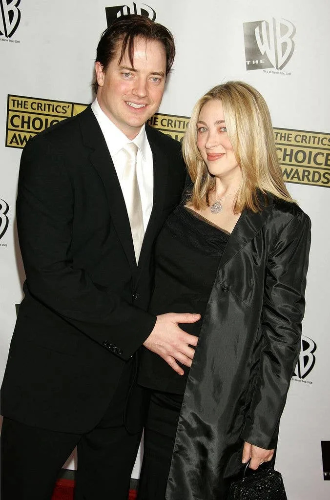 Brendan Fraser holding Afton Smith's stomach