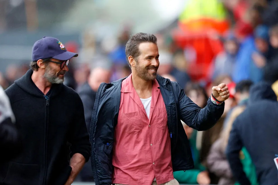 WREXHAM, WALES – AUGUST 05: Co-owner of Wrexham Football Club Ryan Reynolds and actor Hugh Jackman meet fans before the Sky Bet League Two match between Wrexham and Milton Keynes Dons at Stok Cae Ras stadium on August 05, 2023 in Wrexham, Wales. (Photo by Malcolm Couzens/Getty Images)