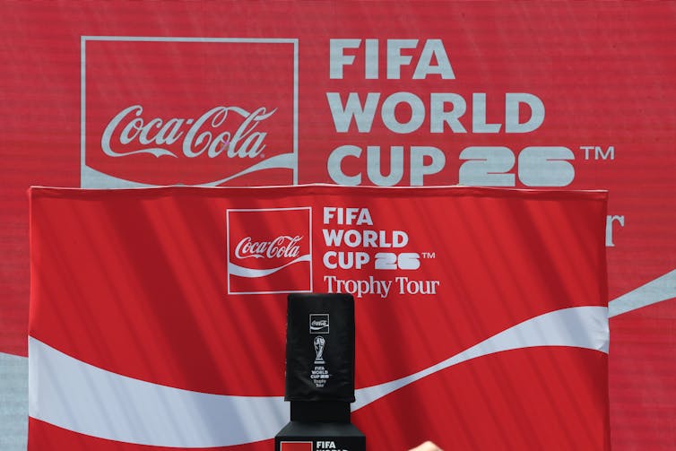 A red banner featuring the Coca-Cola logo and the text 'FIFA World Cup 26.'