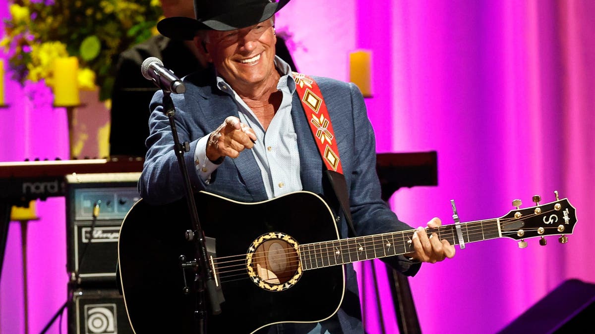 George Strait performing on stage at the Grand Ole Opry in Nashville, Tennessee