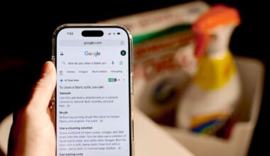 A phone displaying a Google Search AI summary for how to clean in front of cleaning supplies