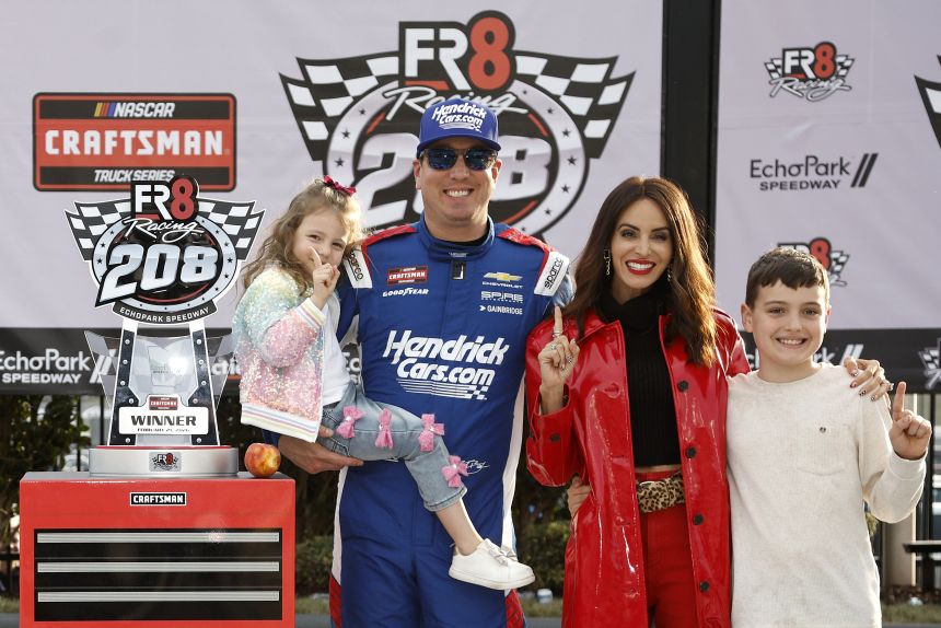 Kyle Busch celebrates with his wife, Samantha, and their children, Lennix and Brexton, after winning a Truck Series race in Hampton, Georgia, in February.