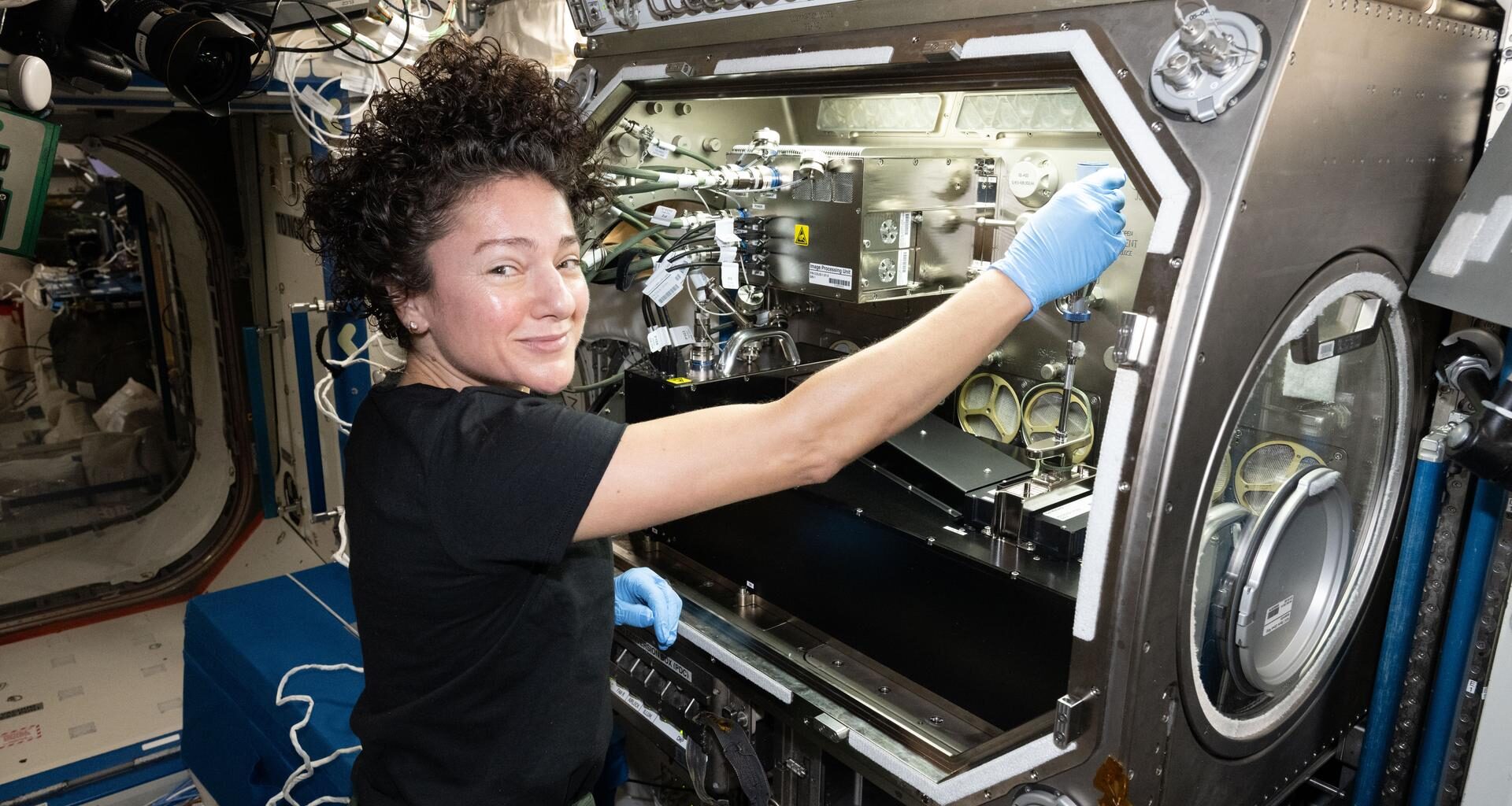 NASA astronaut and Expedition 74 flight engineer Jessica Meir configures research gear inside the Destiny laboratory module's Microgravity Science Glovebox aboard the International Space Station. Meir was exploring how weightlessness affects tiny particles floating in a gelatin-like substance, known as a colloidal solid. Results may lead to advanced manufacturing techniques leading to new medicines, better food textures, and improved personal care products on Earth and in space.