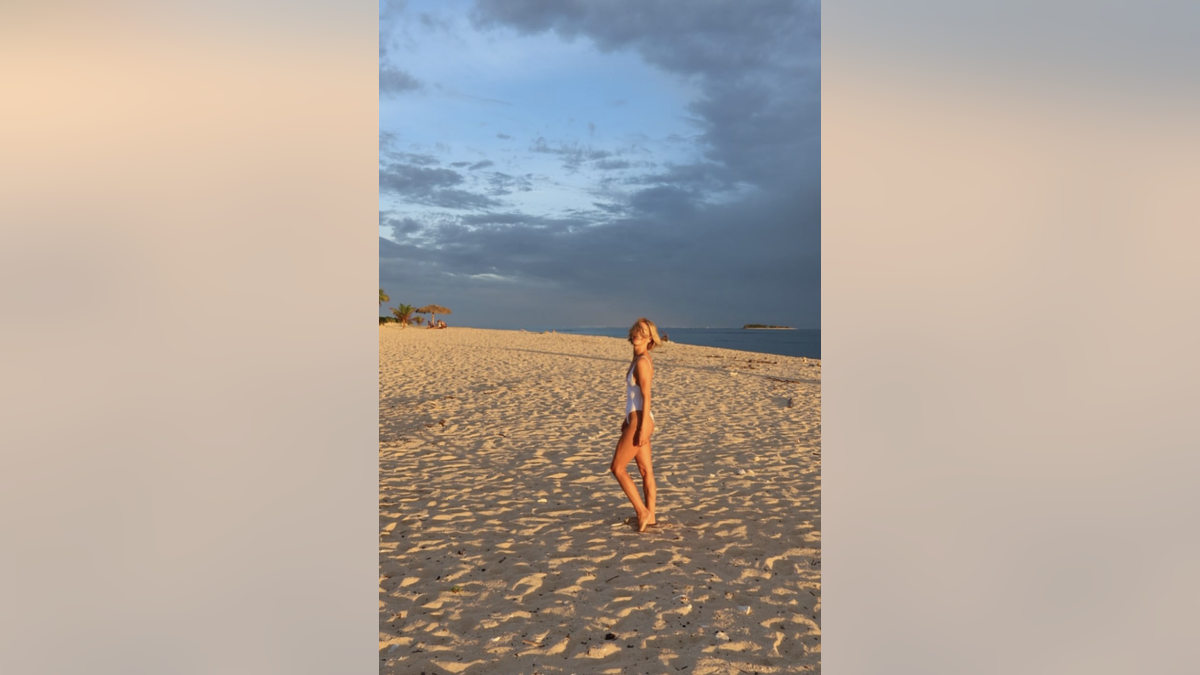 Julianne Hough on the beach in white swimsuit