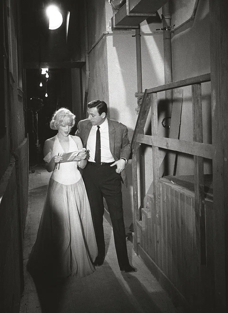 Monroe and co-star Yves Montand discuss the opening scene of “Let’s Make Love” on set, 1960.