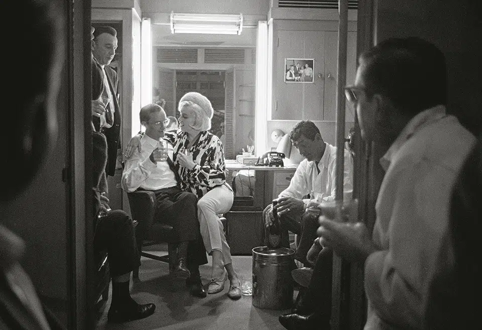 Monroe celebrates her 36th birthday on the set of “Something’s Got to Give” with co-stars Wally Cox (l.), Dean Martin (r.), and Martin’s driver (standing).