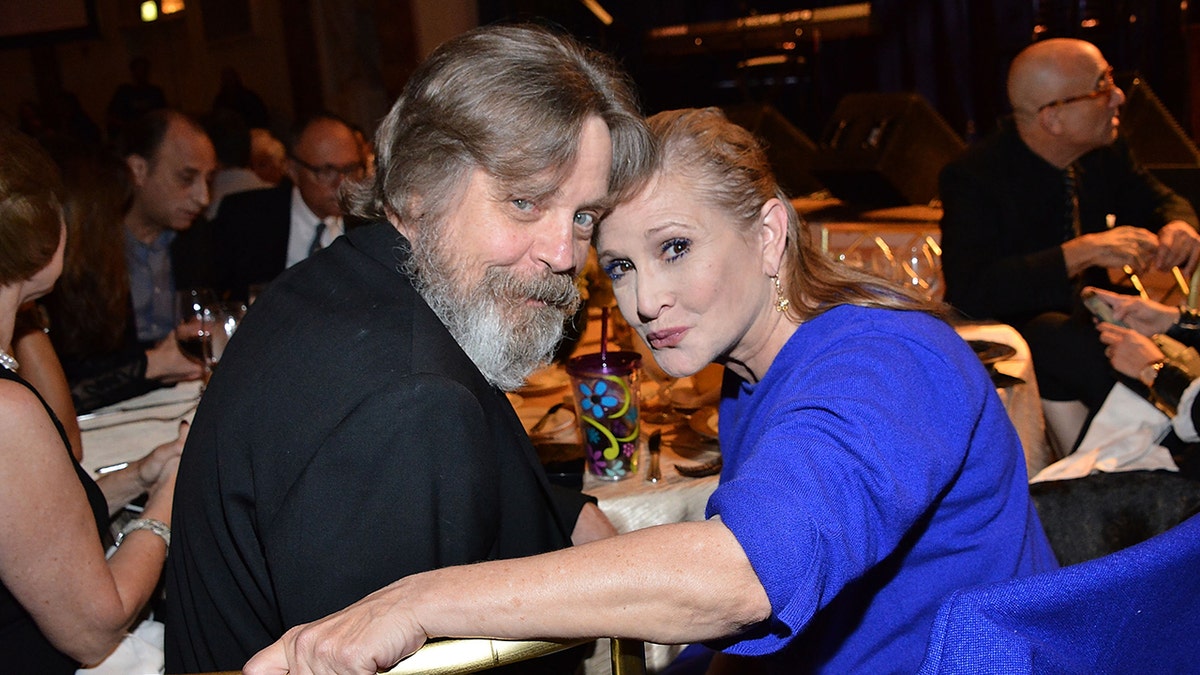 Mark Hamill and Carrie Fisher standing together at an event in Beverly Hills