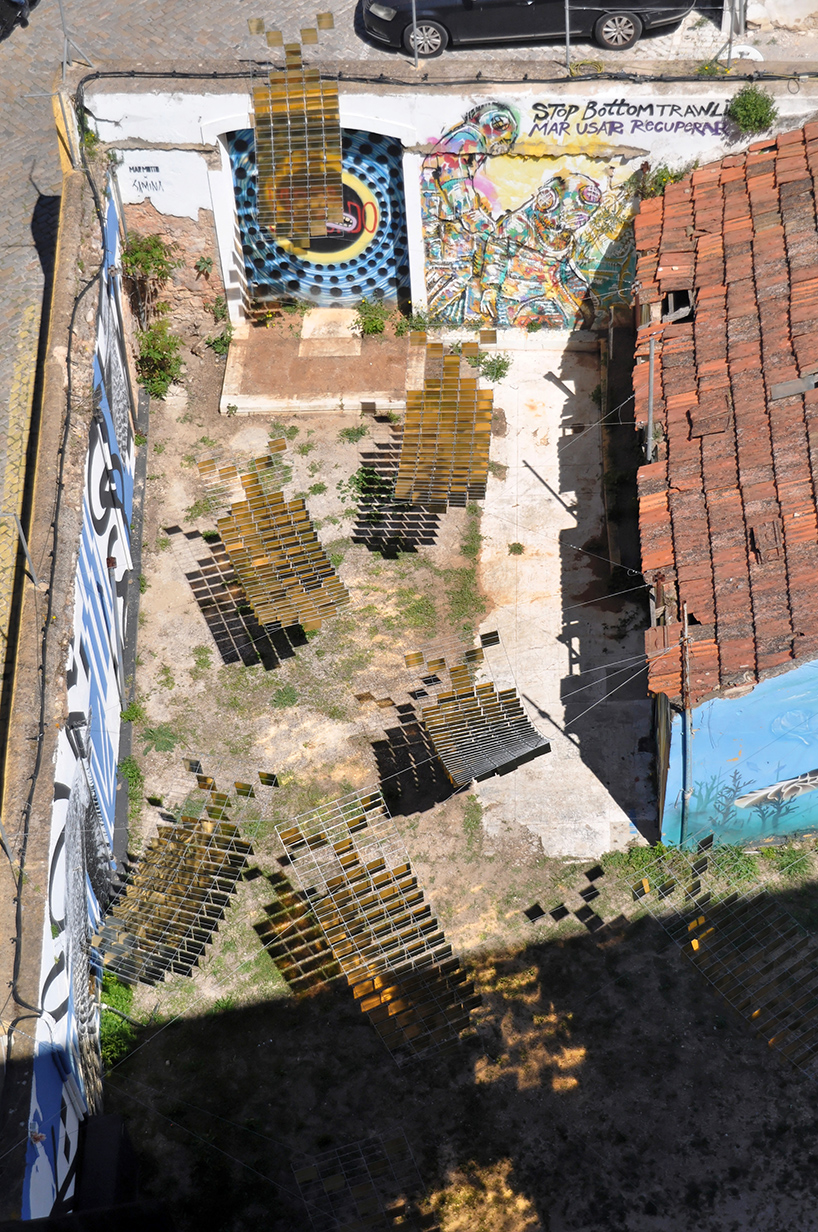 kinetic mirrored installation in portugal by moradavaga evokes a shoal of golden fish - 1