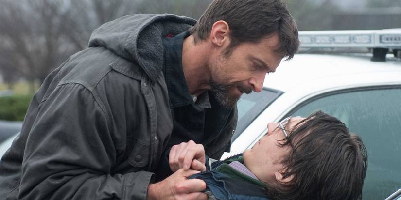 Keller (Hugh Jackman) pins down Alex (Paul Dano) on the hood of a car in 'Prisoners'.