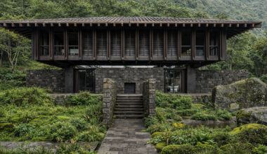 V taller proposes forest retreat around monolithic stone core for NOT A HOTEL in japan