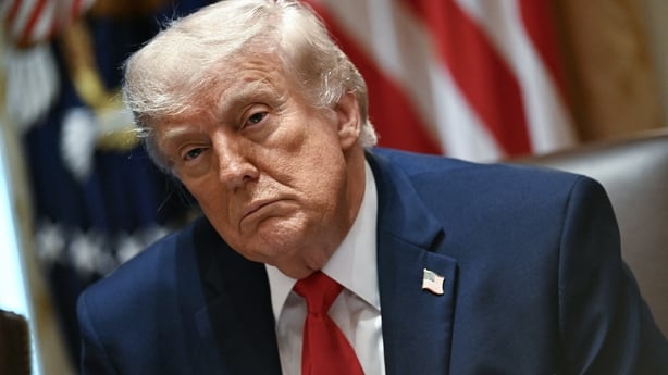 US President Donald Trump looks on during a cabinet meeting 
