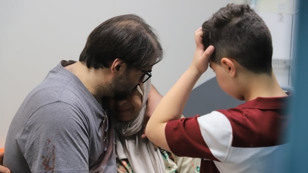 A middle-aged man, an elderly woman and a young boy upset crying and consoling each other
