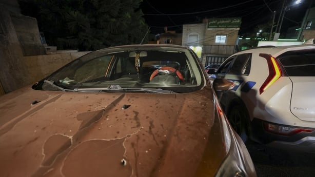 An orange car with a bullet hole in the bonnet and windshield after Israeli forces shot at a Palestinian family, killing a 7-month-old baby boy