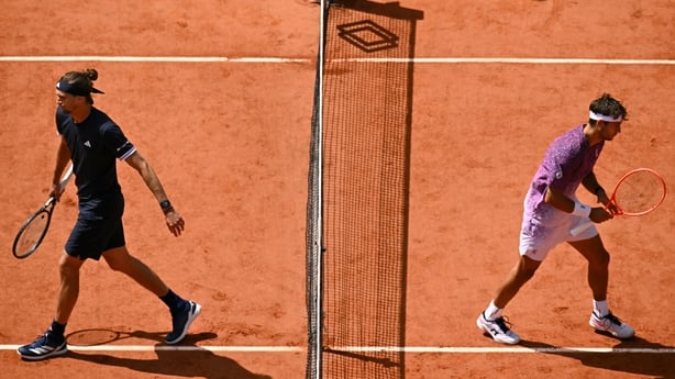 Italy's Flavio Cobolli (R) and Germany's Alexander Zverev (L) arrive on court for their men's final singles match on day 15 of the French Open tennis tournament on Court Philippe-Chatrier at the Roland-Garros Complex in Paris on June 7, 2026.