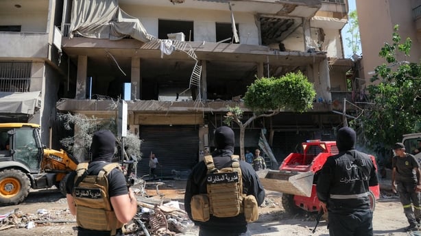 Lebanese army soldiers stand guard as people clear the rubble at the site of an Israeli airstrike that targeted a building in Beirut's southern suburbs on June 14, 2026. The office of Israeli Prime Minister Benjamin Netanyahu said on June 14 the military had carried out strikes in Beirut's southern