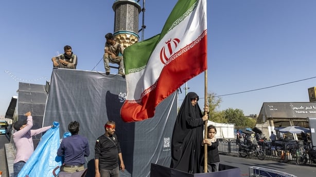  A woman is seen holding the Iranian flag on in Tehran, Iran