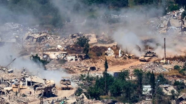 This picture taken from a position in the Upper Galilee in northern Israel, near the Israel-Lebanon border shows Israeli Merkava tanks driving along a road past destroyed buildings in southern Lebanon on June 17, 2026. Lebanon and Israel have been holding direct talks in Washington since April, seek
