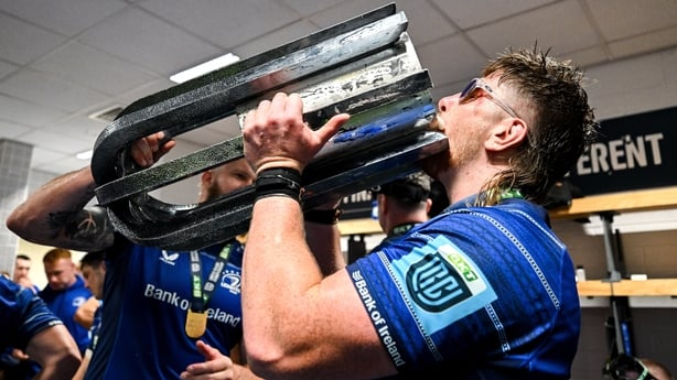 14 June 2025; Joe McCarthy of Leinster celebrates with the URC trophy in the dressingroom after the United Rugby Championship Grand Final match between Leinster and Vodacom Bulls at Croke Park in Dublin. Photo by Brendan Moran/Sportsfile