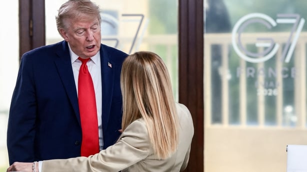US President Donald Trump speaks with Italy's Prime Minister Giorgia Meloni