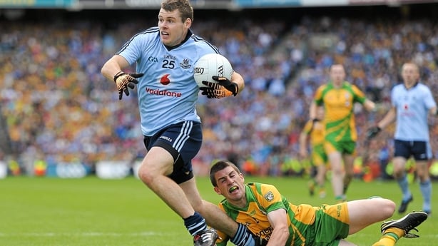 Kevin McManamon gets past the challenge of Paddy McGrath