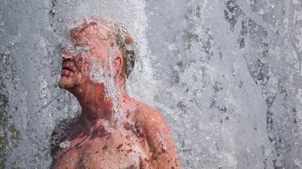 A man cools off in a fountain the German capital, Berlin