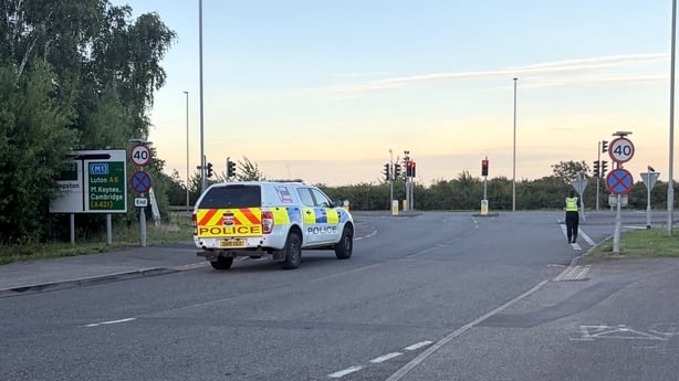 Police close a road in Bedford after train crash