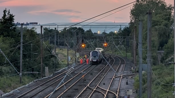 Emergency services are seen on a train track in the UK after two trains collided in the Bedford area